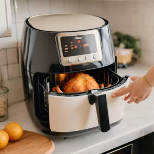 our editor placing the air fryer basket in the air fryer with prepared chicken inside it