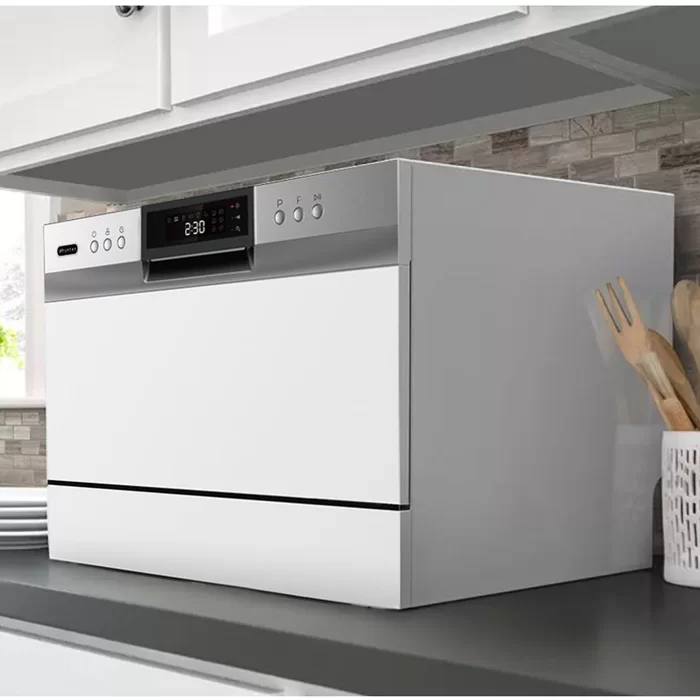 “A modern, white dishwasher with a digital display showing ‘2:30’, positioned under a grey countertop in a bright, contemporary kitchen.”