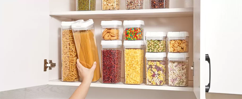 Kitchen showcasing a standardized set of storage containers placed on a cabinet