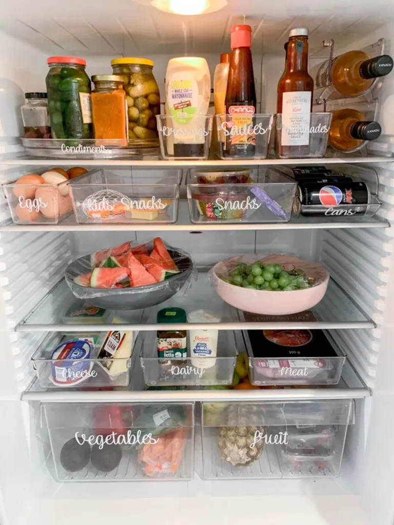 a showcase of an opened fridge with fridge labels marked on bins 