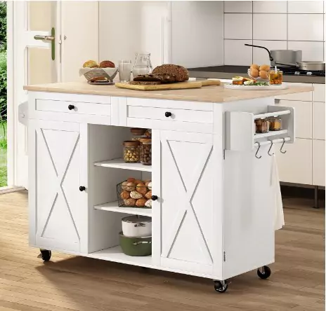 A white kitchen island cart with wooden top, shelves, drawers, and hooks, stocked with various food items and utensils, positioned in a modern kitchen.
