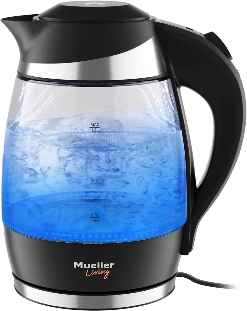 A Mueller 1.8 Liter Ultra Kettle with boiling water inside, illuminated with a blue light. The kettle has measurement markings on the side and is branded “Mueller Living” at the base.
