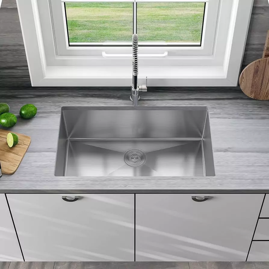 single bowl kitchen sink on a kitchen countertop infront of a kitchen window