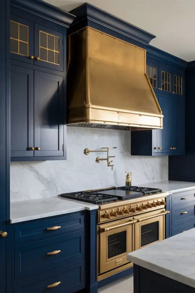 A stunning, luxurious kitchen design featuring a captivating navy blue and brass color palette. The navy blue cabinets, adorned with exquisite brass hardware and fixtures, create a rich and sophisticated atmosphere. The contrasting white marble countertops provide a clean and elegant touch, while the impressive brass range hood adds a touch of opulence. The overall ambiance of this kitchen is both refined and inviting, perfect for a gourmet culinary experience.