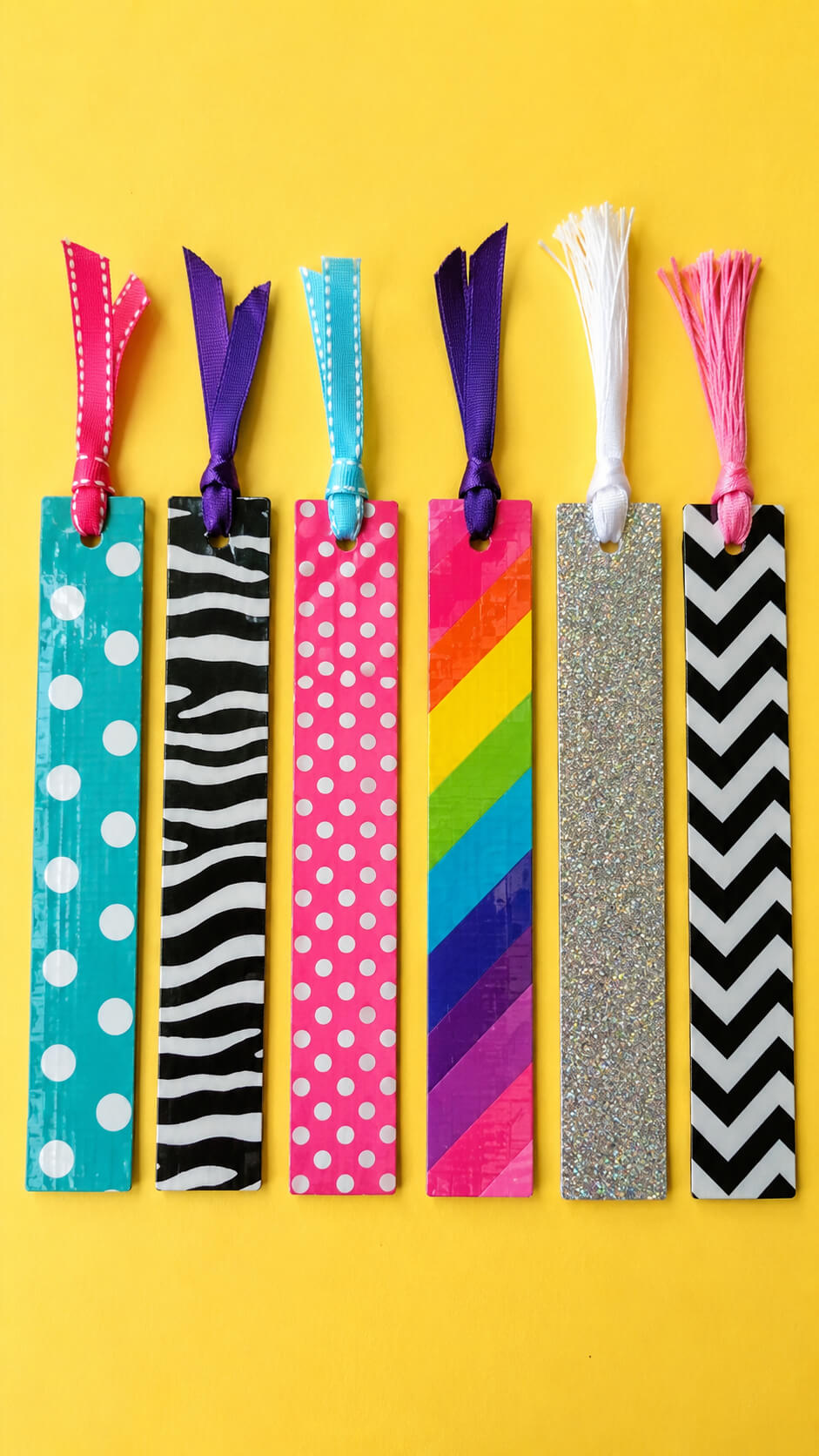 Colorful handmade bookmarks on yellow surface
