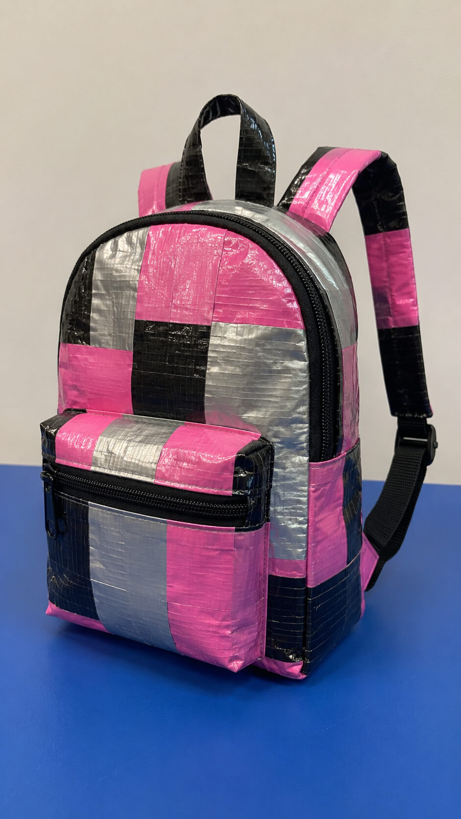 Handmade duct tape backpack on blue surface
